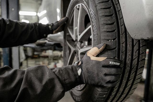 Professional mobile tyre fitting service showing technician fitting new tyre at customer location in the UK